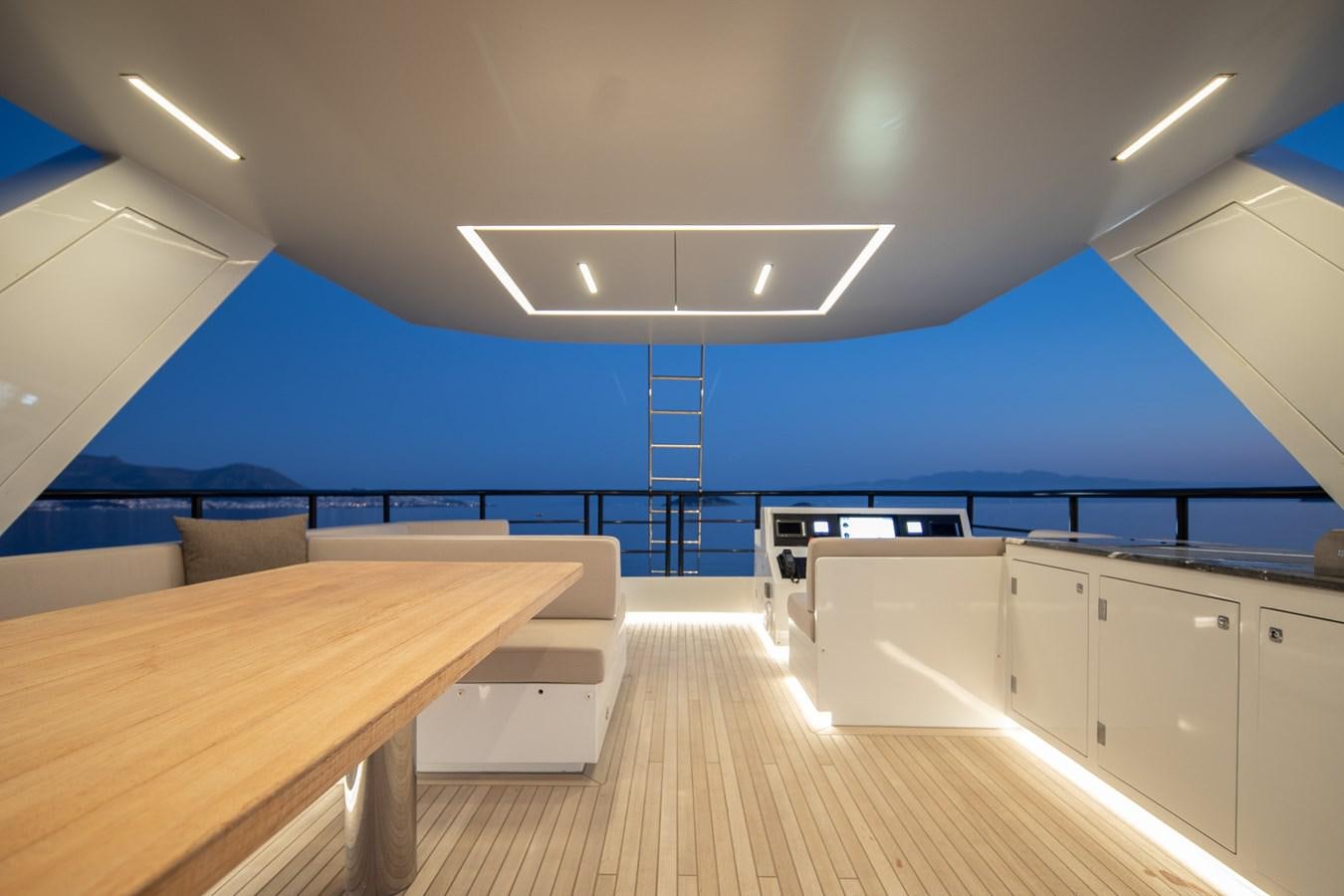 a room with a table and chairs aboard EZGY Yacht for Sale