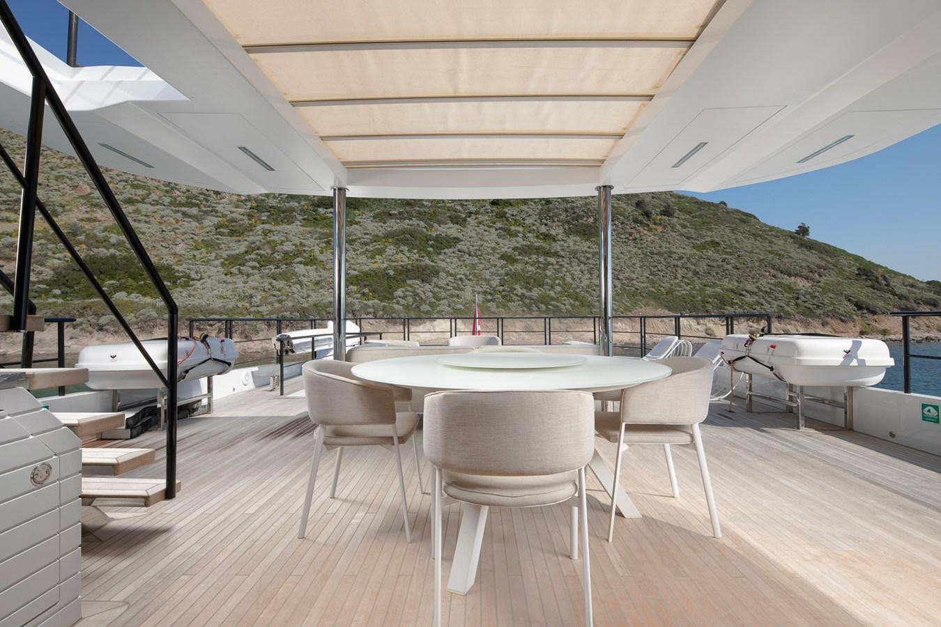 a table and chairs on a deck aboard EZGY Yacht for Sale