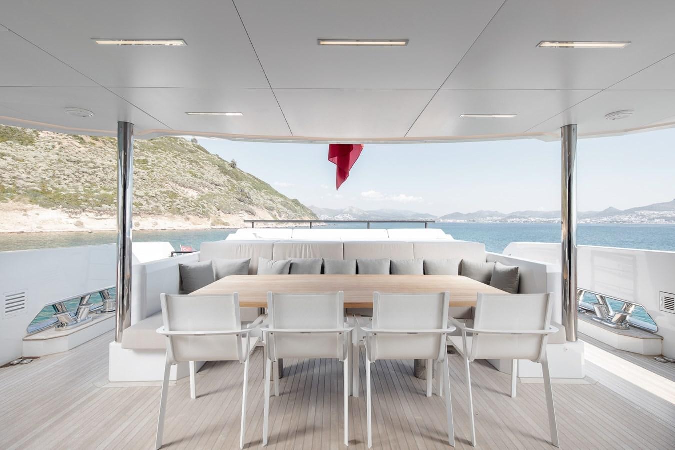 a deck with chairs and a flag aboard EZGY Yacht for Sale