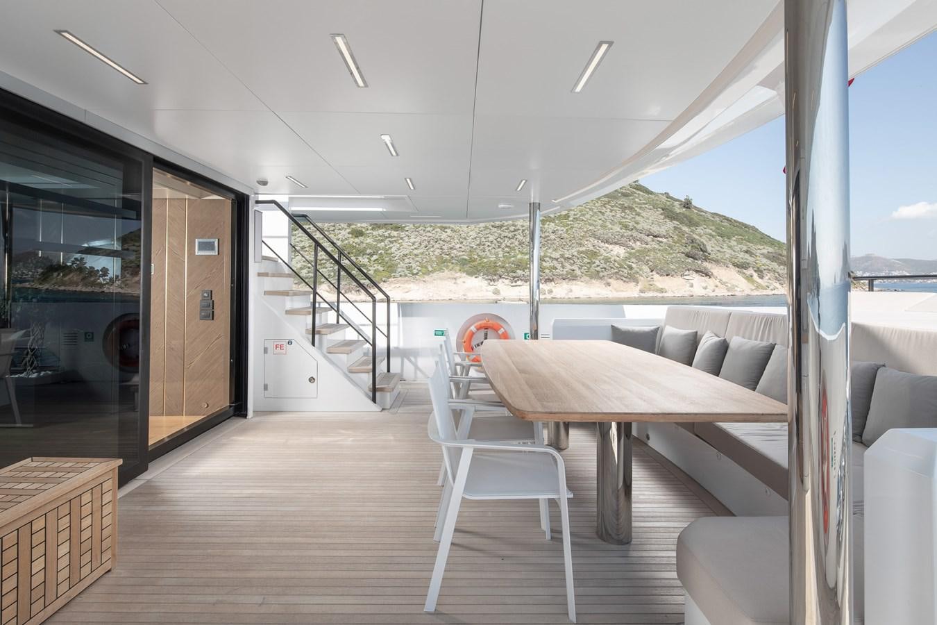 a room with a table and chairs aboard EZGY Yacht for Sale