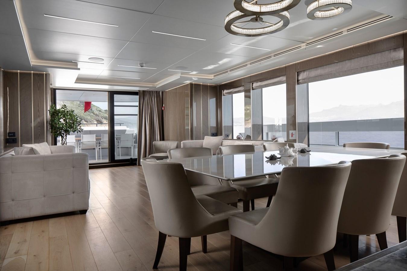 a large room with a table and chairs aboard EZGY Yacht for Sale