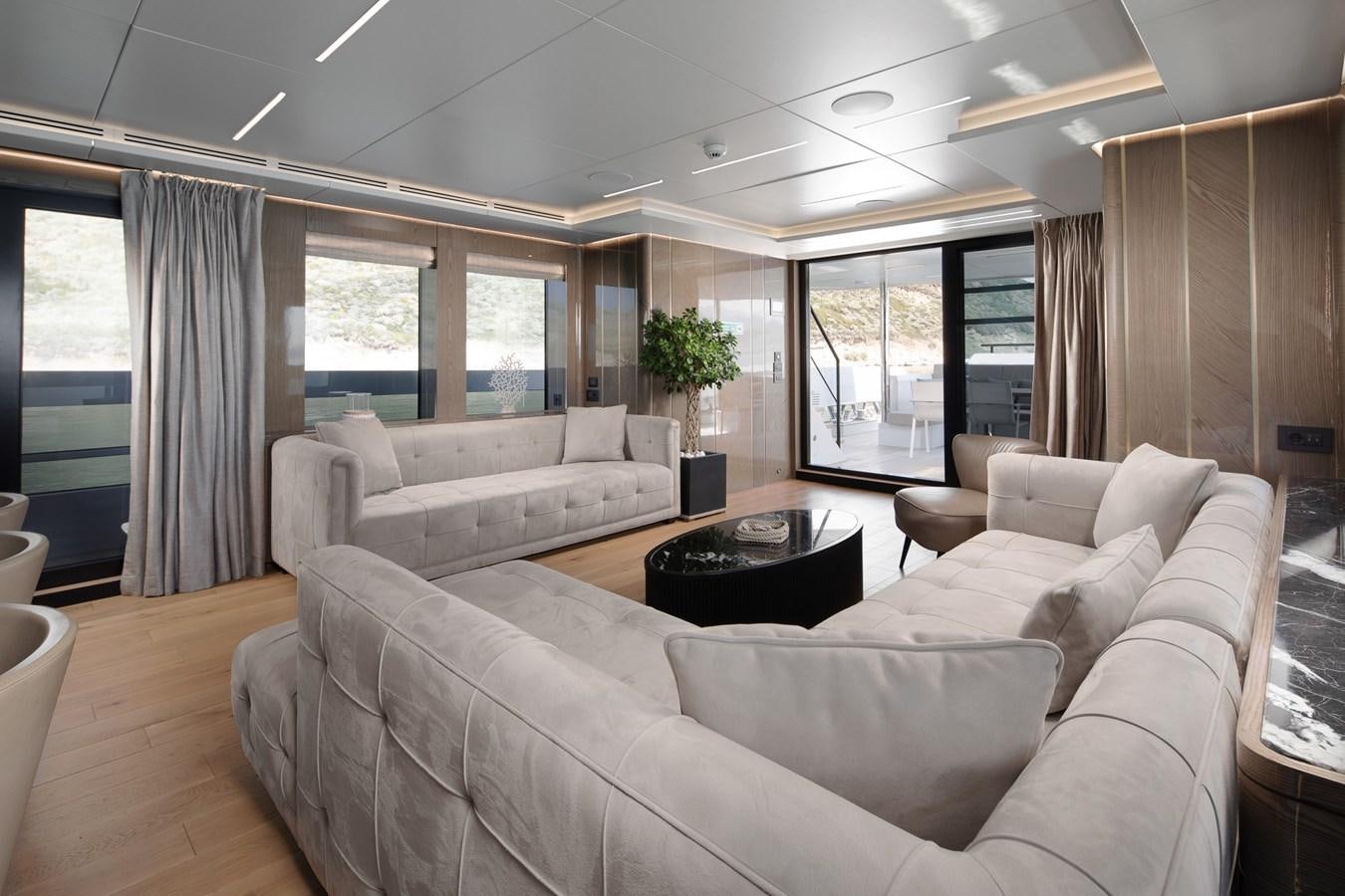 a living room with white couches aboard EZGY Yacht for Sale