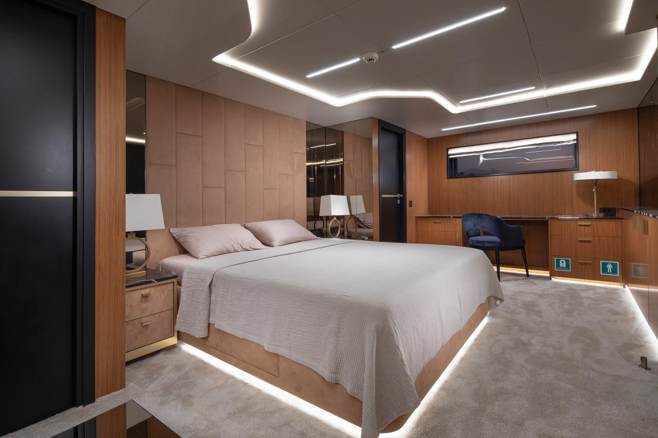 a room with a bed and a chair aboard EZGY Yacht for Sale