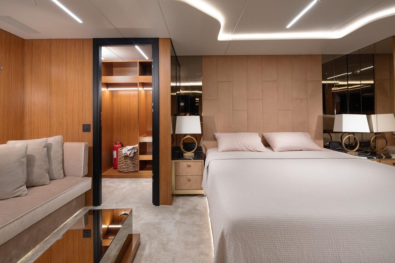 a room with a bed and a mirror aboard EZGY Yacht for Sale