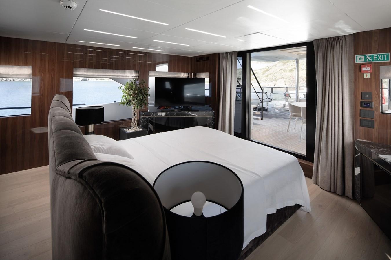 a room with a bed and a table aboard EZGY Yacht for Sale
