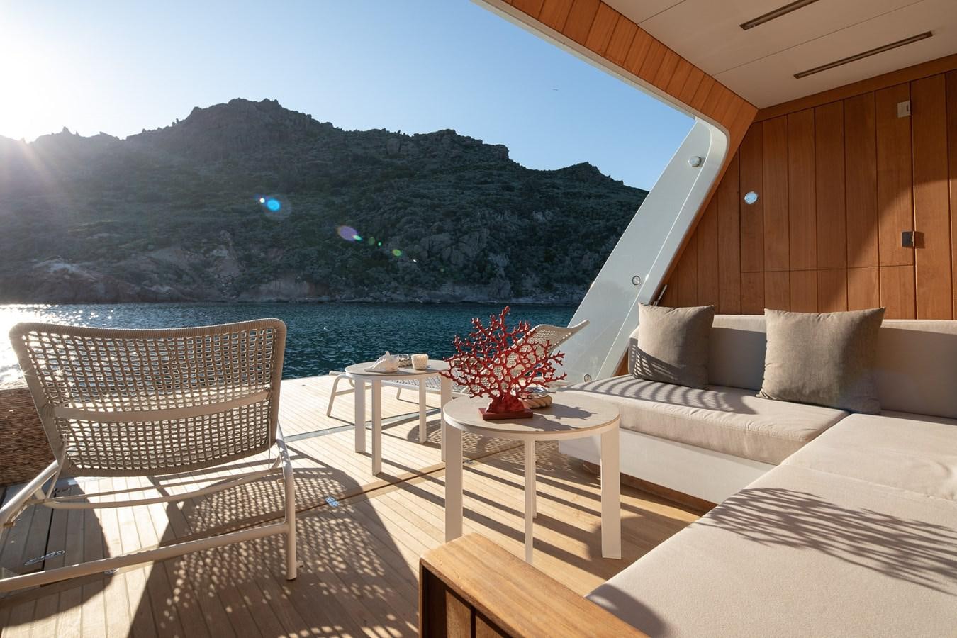 a room with a couch and a table and a large window aboard EZGY Yacht for Sale