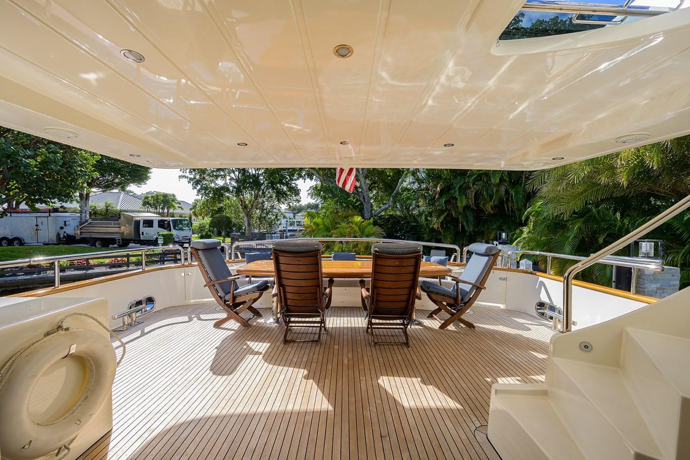 a room with a table chairs and a pool aboard 82 Yacht for Sale