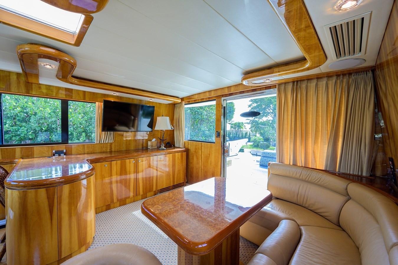 a living room with a table and couches aboard 82 Yacht for Sale