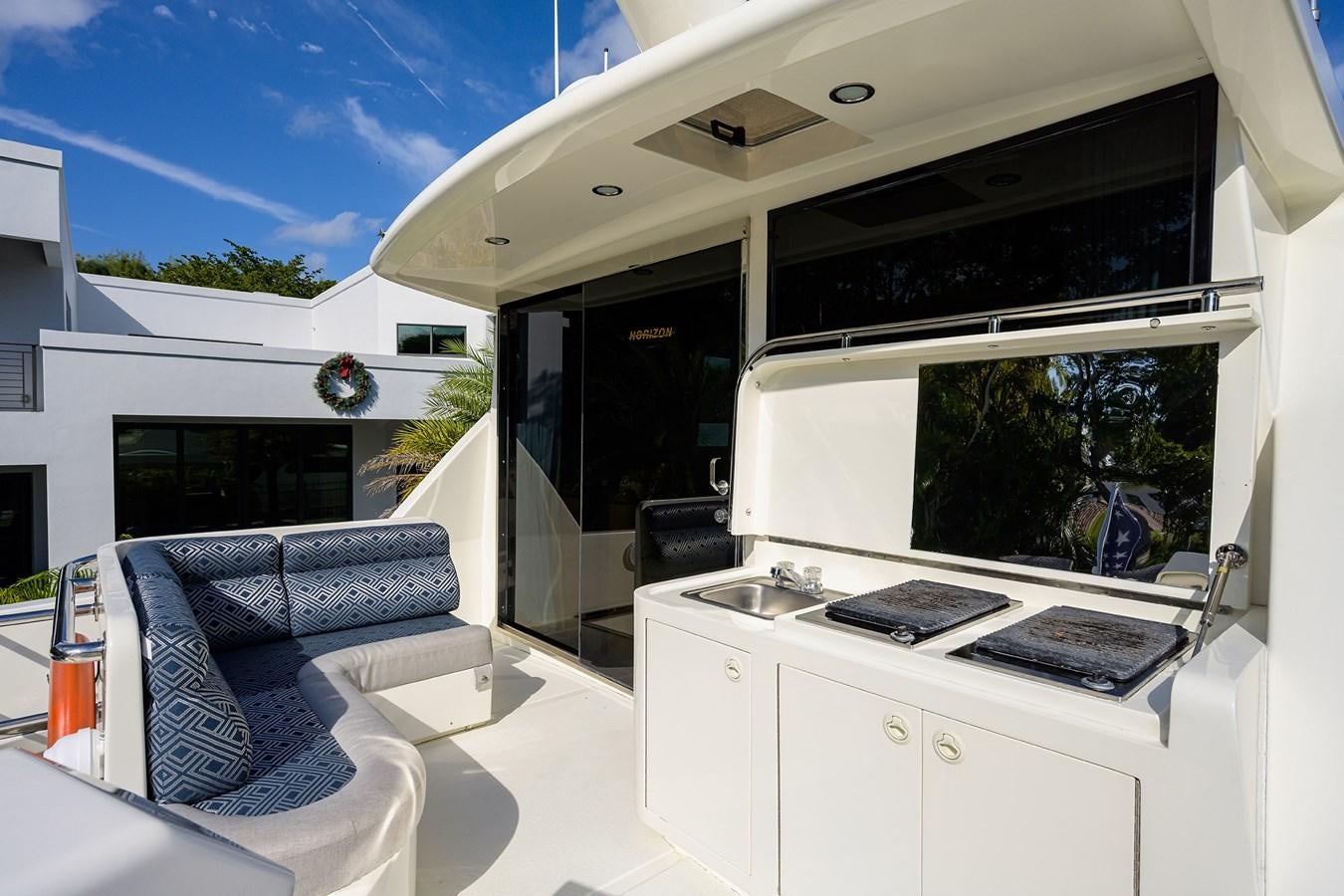 a white kitchen with a large window aboard 82 Yacht for Sale