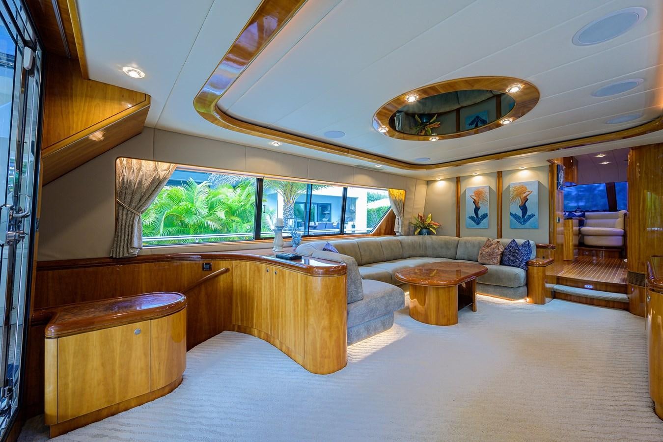 a large living room with a large chandelier aboard 82 Yacht for Sale