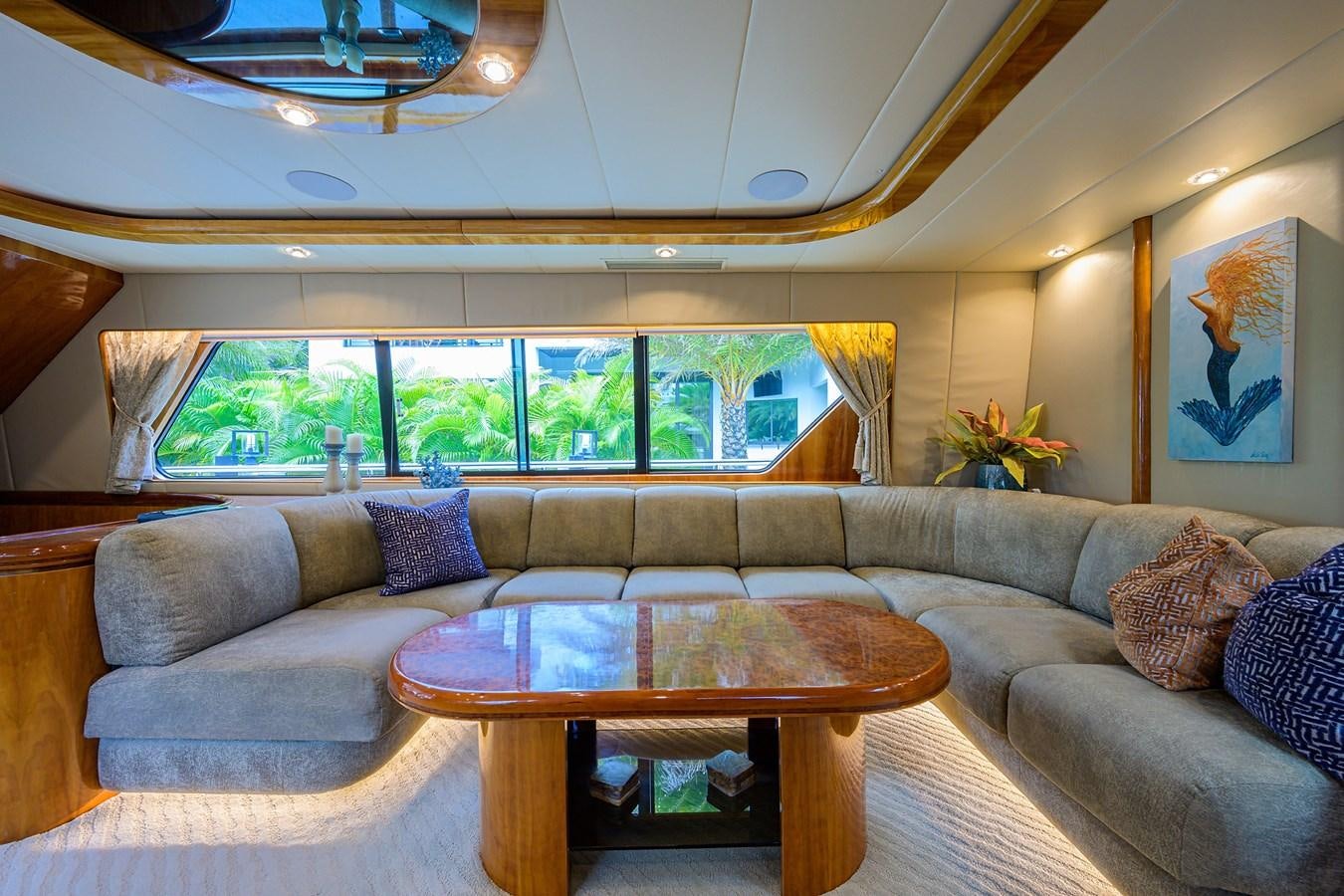 a living room with a sectional sofa aboard 82 Yacht for Sale
