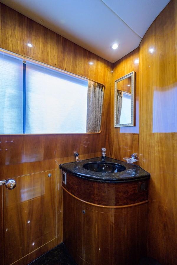 a bathroom with a sink and a window aboard 82 Yacht for Sale