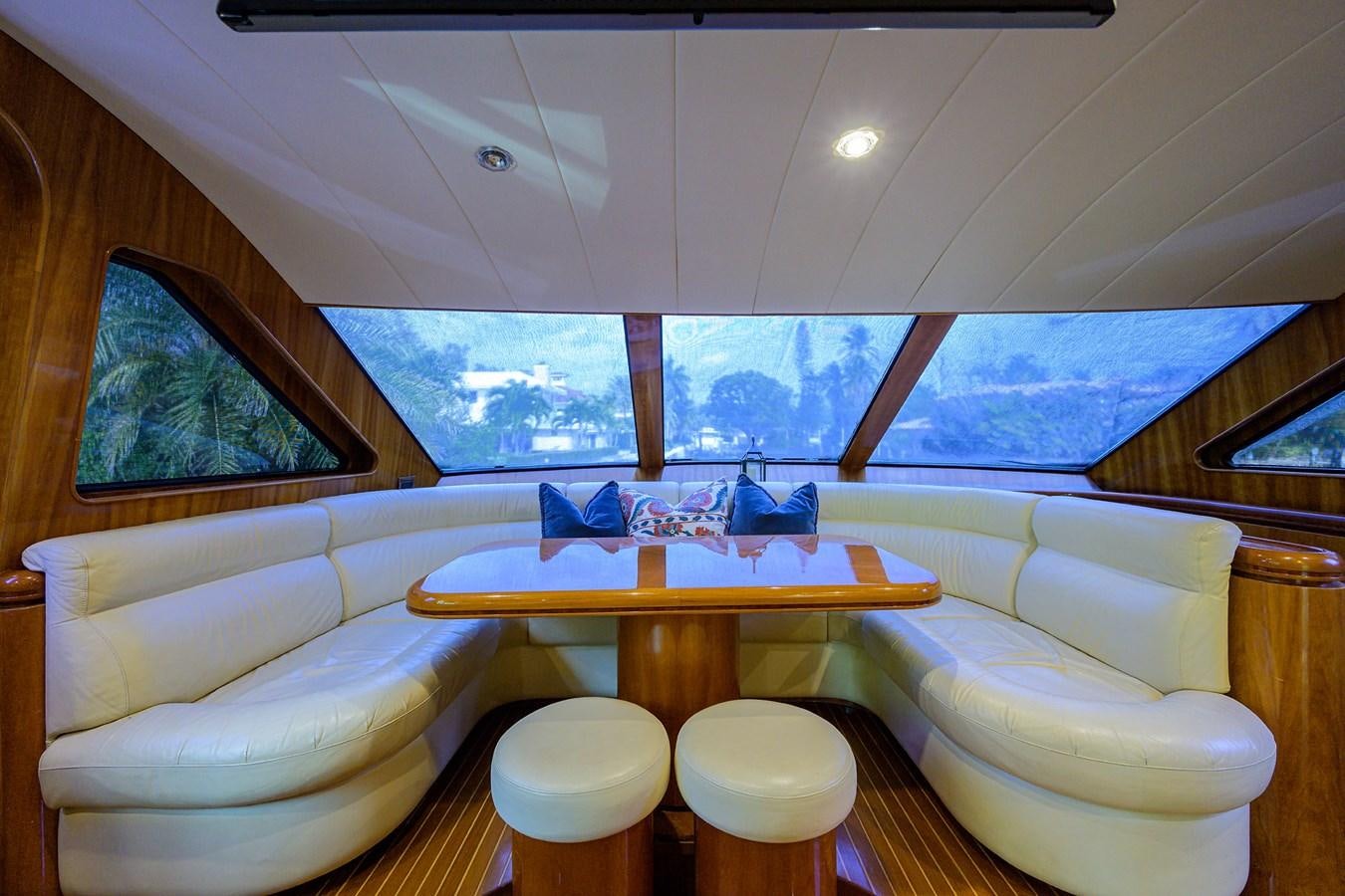 a room with a table and chairs aboard 82 Yacht for Sale