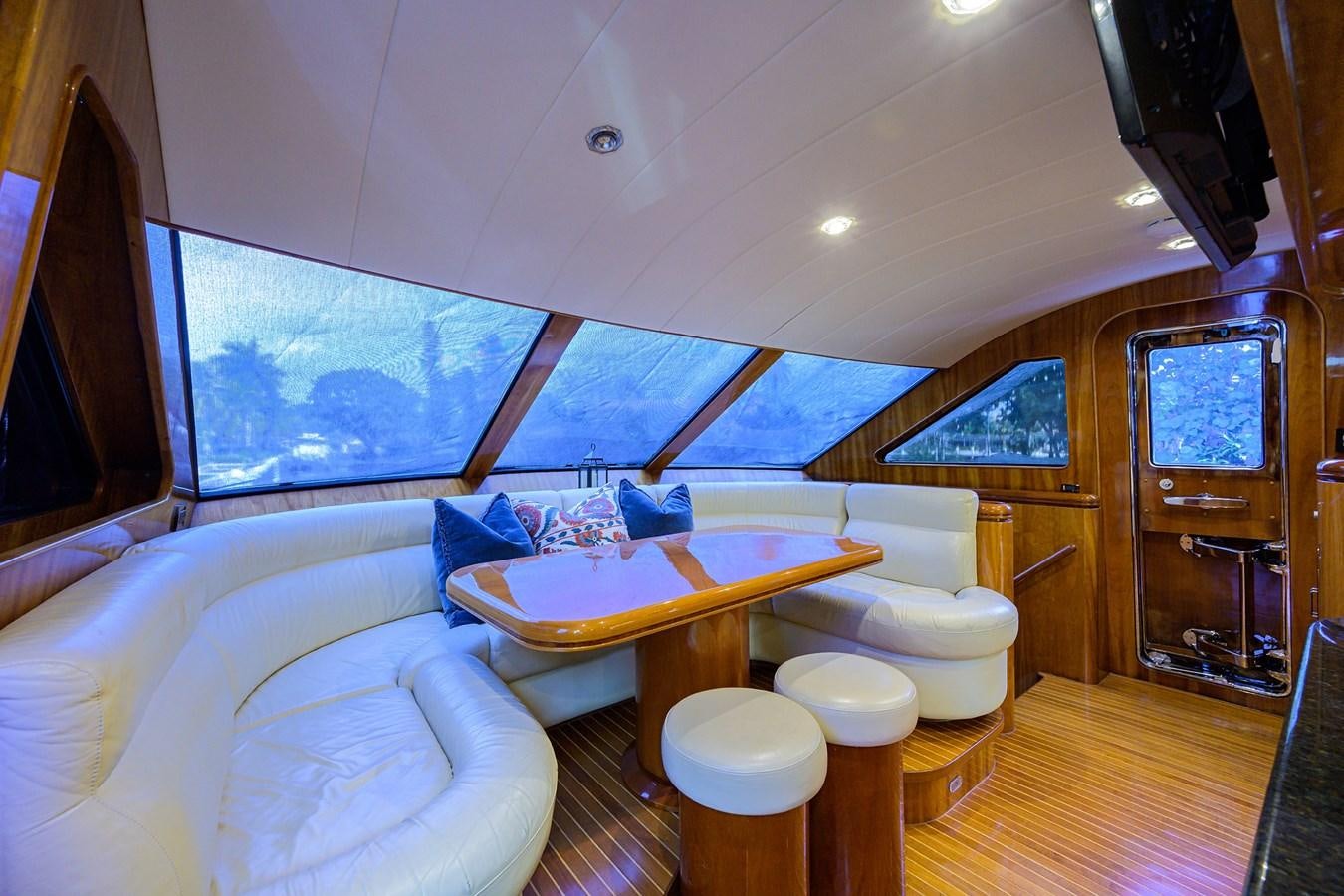a room with a table and chairs aboard 82 Yacht for Sale