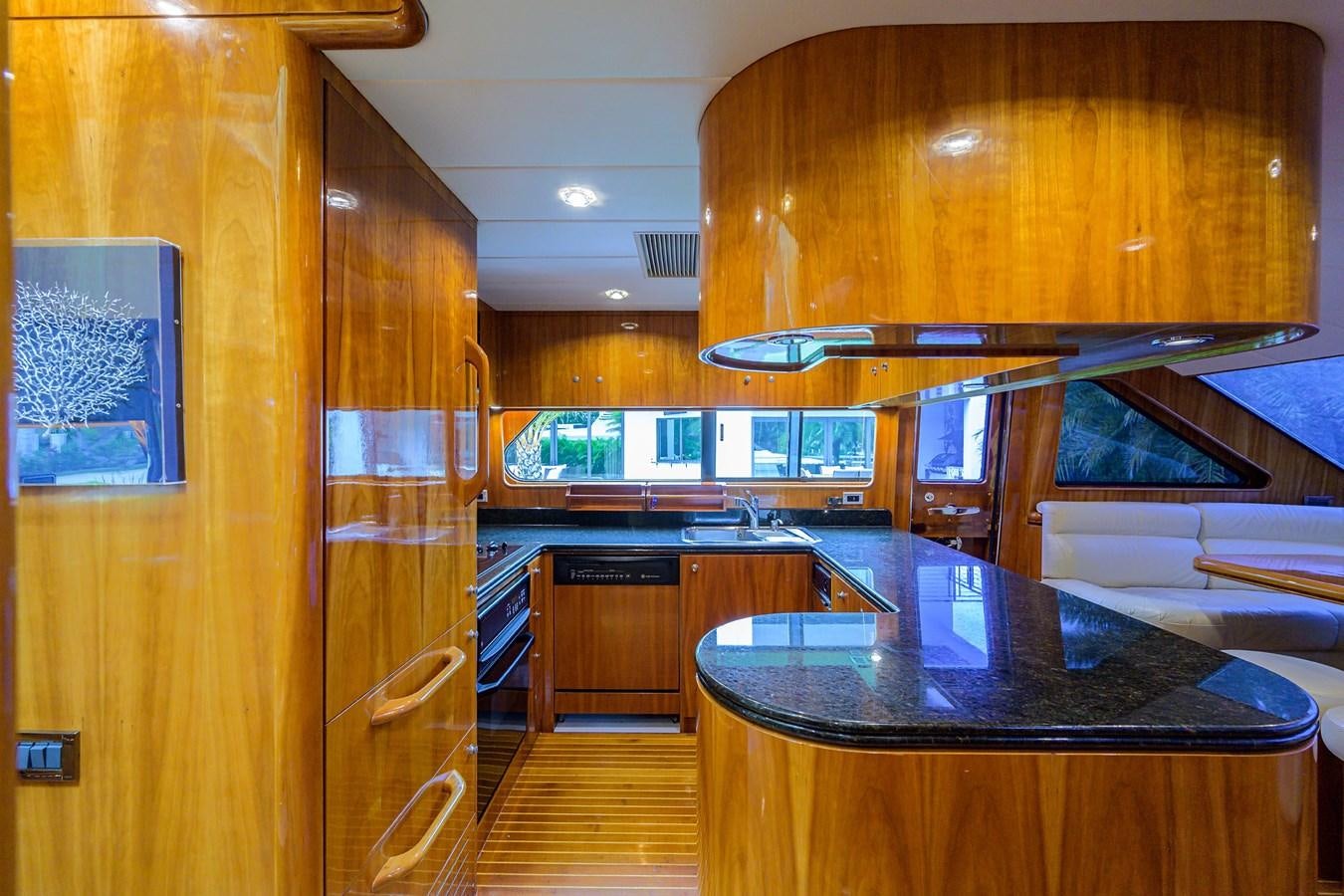 a kitchen with wooden cabinets aboard 82 Yacht for Sale