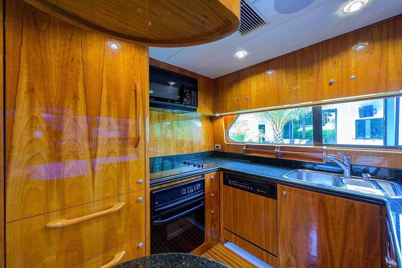 a kitchen with wooden cabinets aboard 82 Yacht for Sale