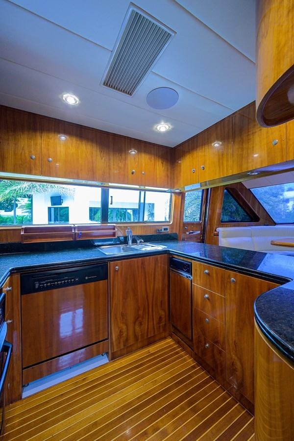 a kitchen with wooden cabinets aboard 82 Yacht for Sale