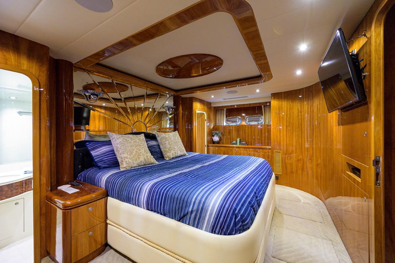a bedroom with a bed and a wood wall aboard 82 Yacht for Sale
