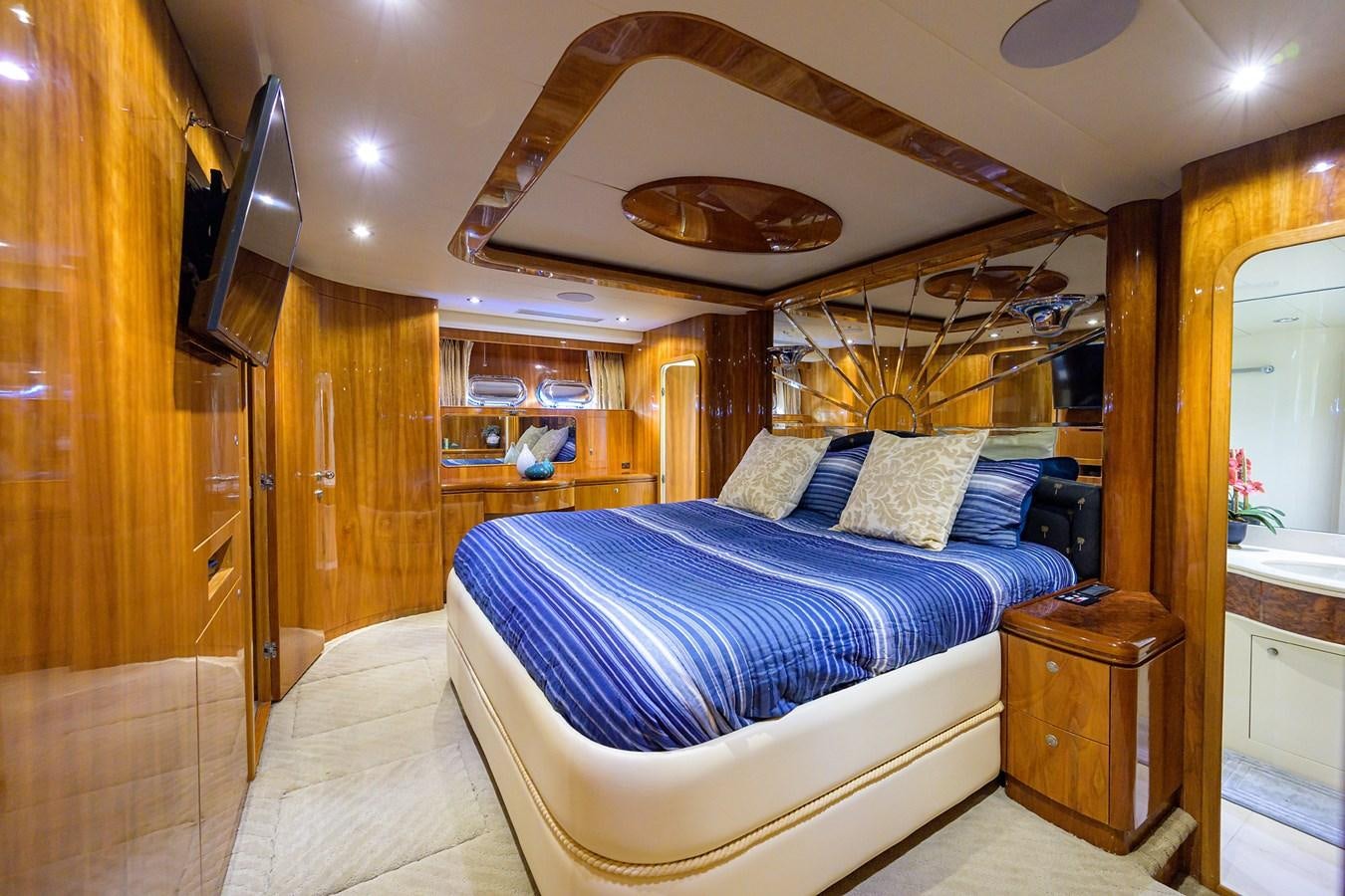 a bedroom with a bed and a wood door aboard 82 Yacht for Sale