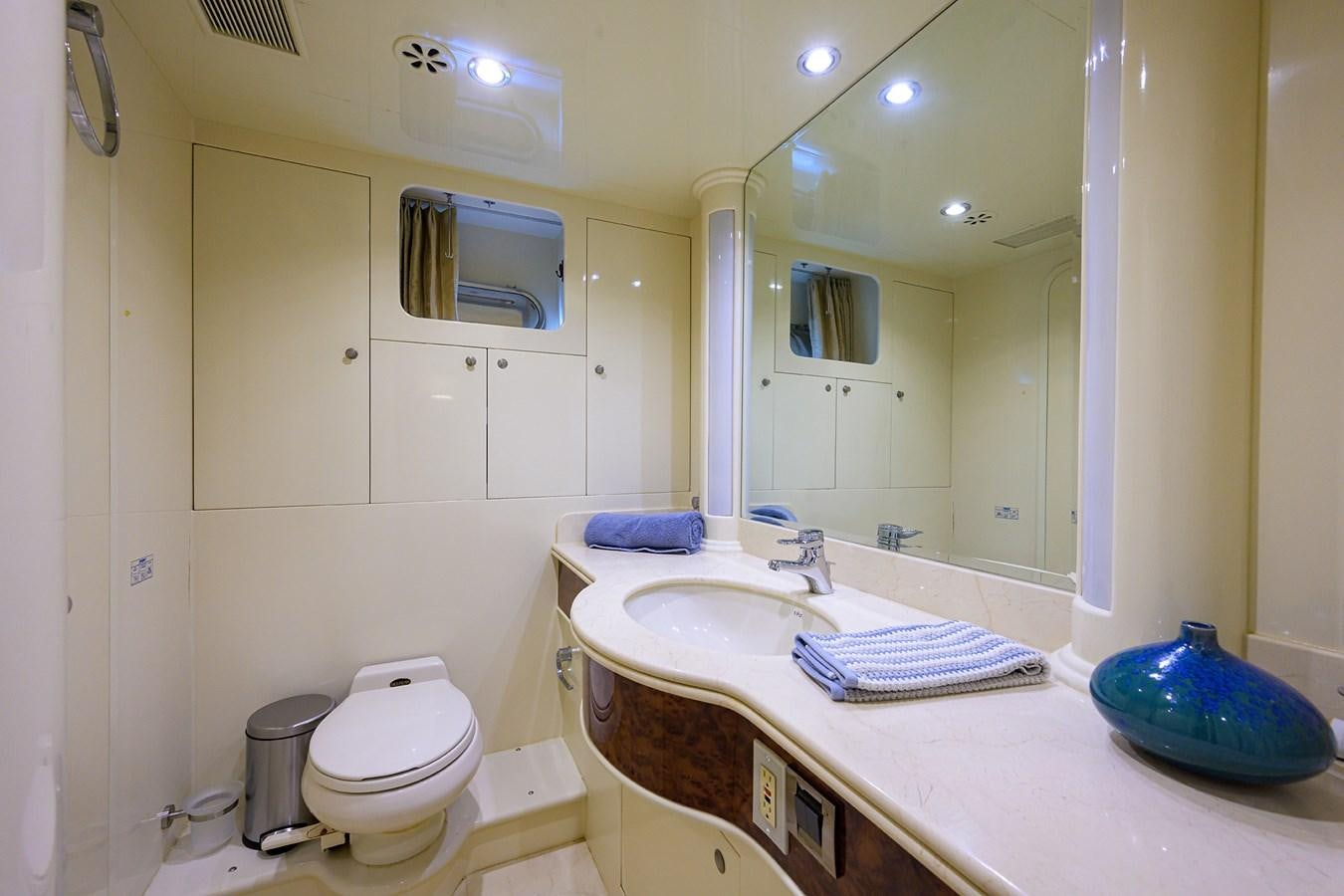 a bathroom with a sink toilet and a mirror aboard 82 Yacht for Sale