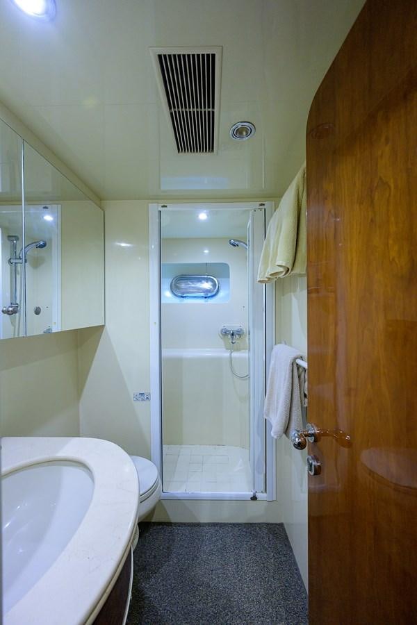 a bathroom with a glass shower aboard 82 Yacht for Sale