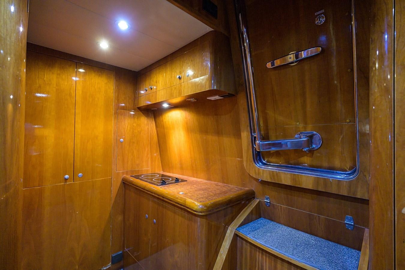 a room with a wood cabinet and a metal bar aboard 82 Yacht for Sale