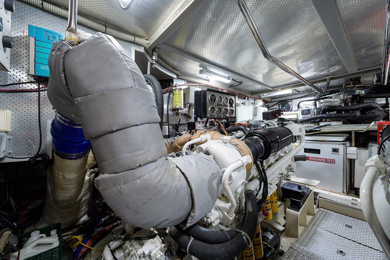 a person in a white suit and blue pants working in a factory aboard 82 Yacht for Sale