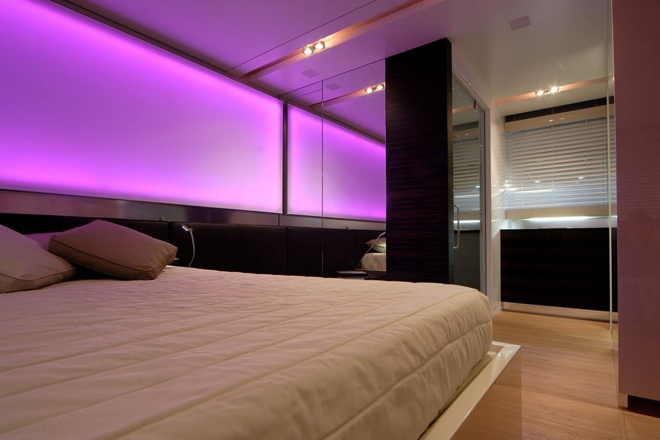 a bedroom with a purple wall aboard MIKYMAR Yacht for Sale