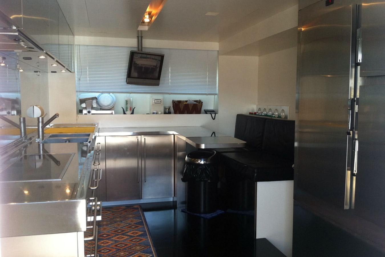 a kitchen with a black counter and stainless steel appliances aboard MIKYMAR Yacht for Sale