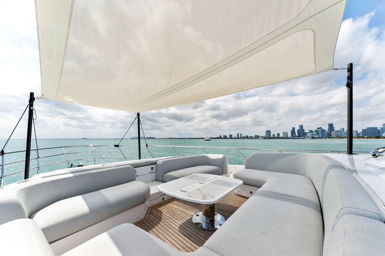 a lounge area with a table and chairs on it aboard NENA Yacht for Sale
