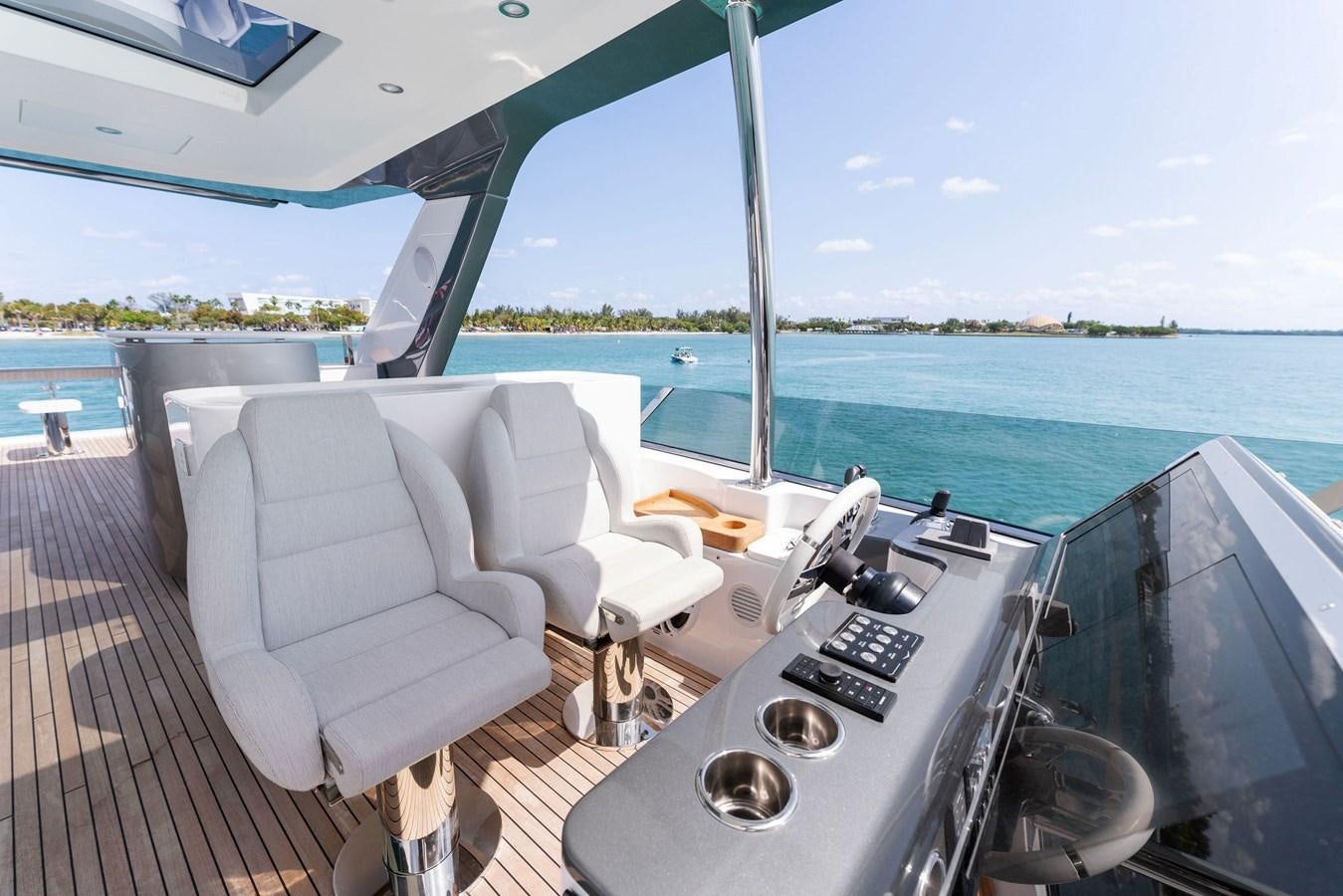 a deck with a chair and a table on it aboard NENA Yacht for Sale