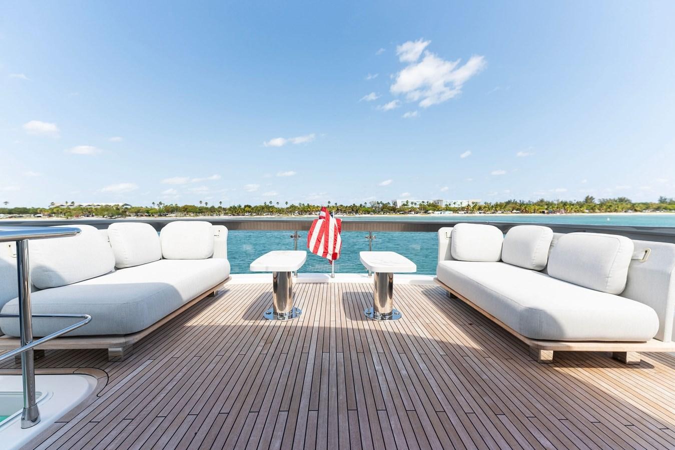 a deck with chairs and a pool aboard NENA Yacht for Sale