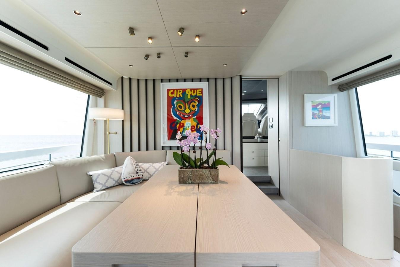 a living room with a large white couch and a table aboard NENA Yacht for Sale
