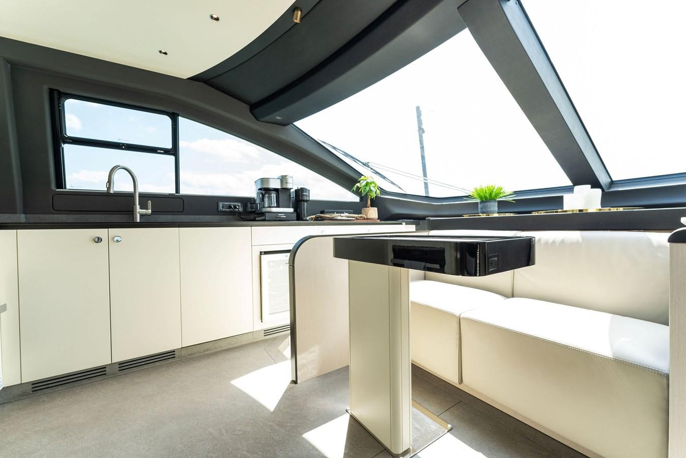 a kitchen with a large window aboard NENA Yacht for Sale