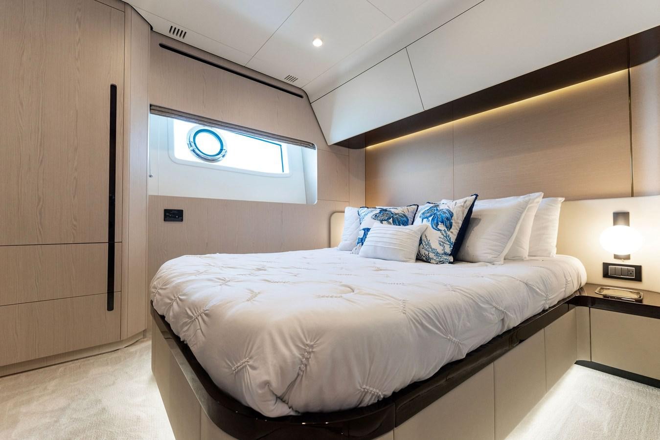 a bed with white sheets aboard NENA Yacht for Sale