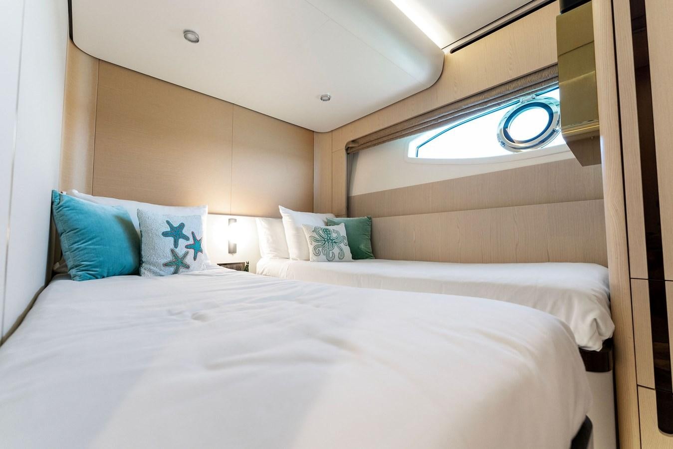 a bed with white sheets aboard NENA Yacht for Sale