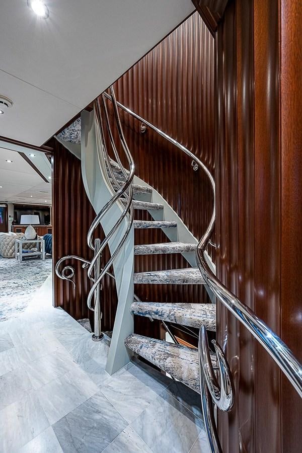 a staircase with wood railings aboard LAGNIAPPE Yacht for Sale