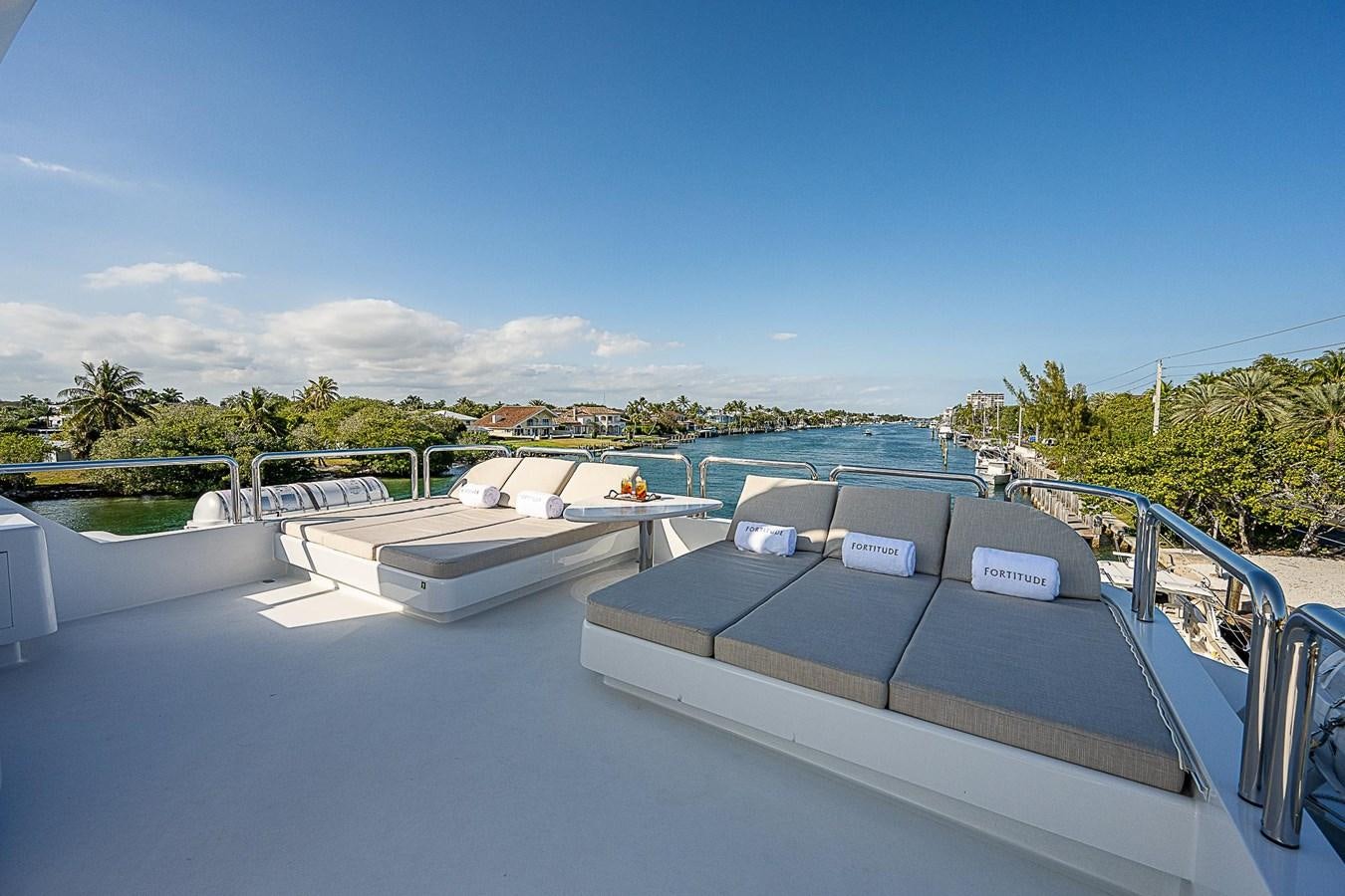 a pool with a deck and chairs aboard LAGNIAPPE Yacht for Sale
