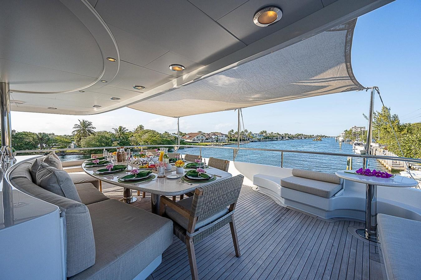 a table and chairs on a deck aboard LAGNIAPPE Yacht for Sale