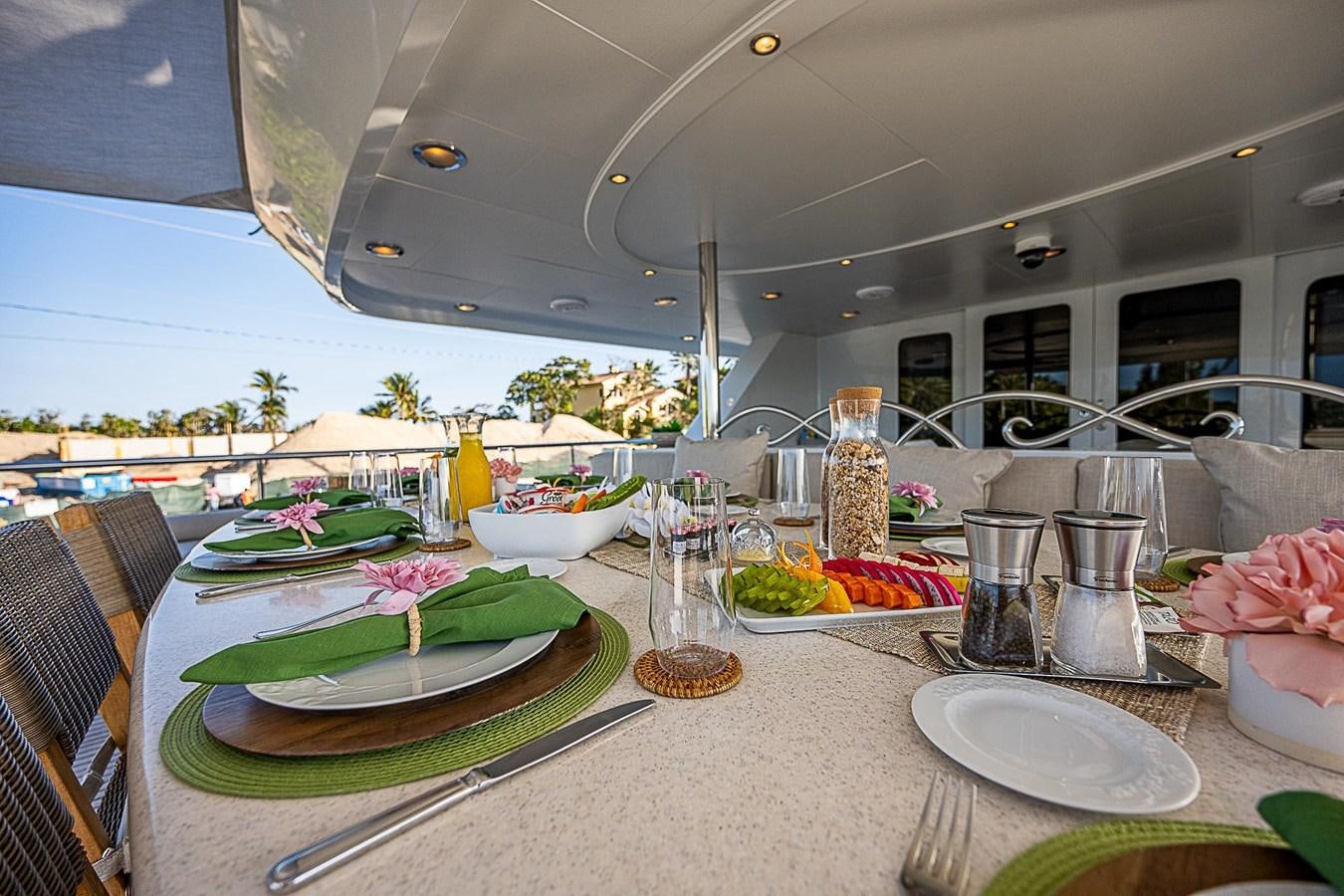a table with plates and glasses aboard LAGNIAPPE Yacht for Sale