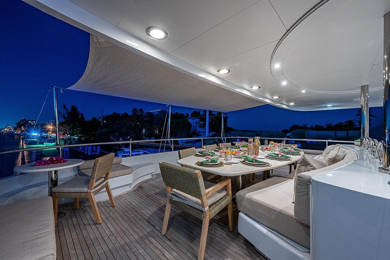 a table and chairs on a deck aboard LAGNIAPPE Yacht for Sale