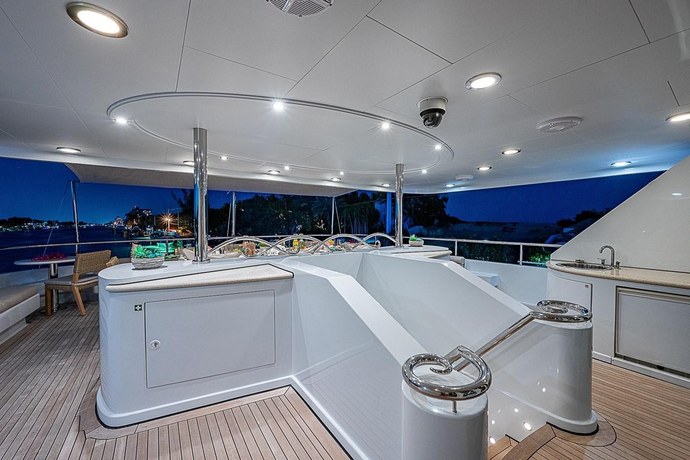 a large white kitchen with a large window overlooking a city aboard LAGNIAPPE Yacht for Sale