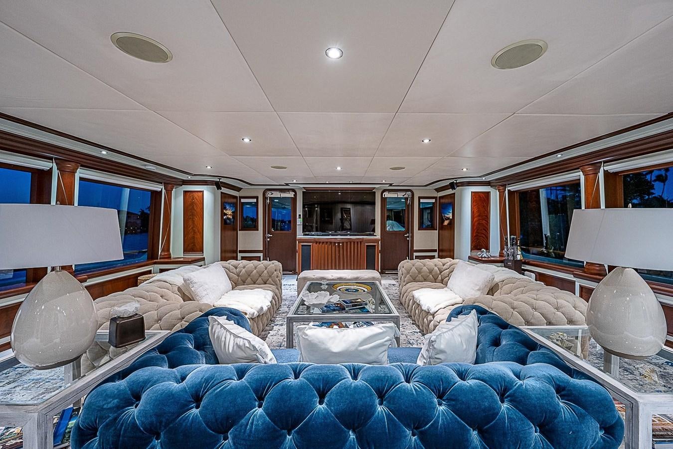 a living room with a blue couch aboard LAGNIAPPE Yacht for Sale