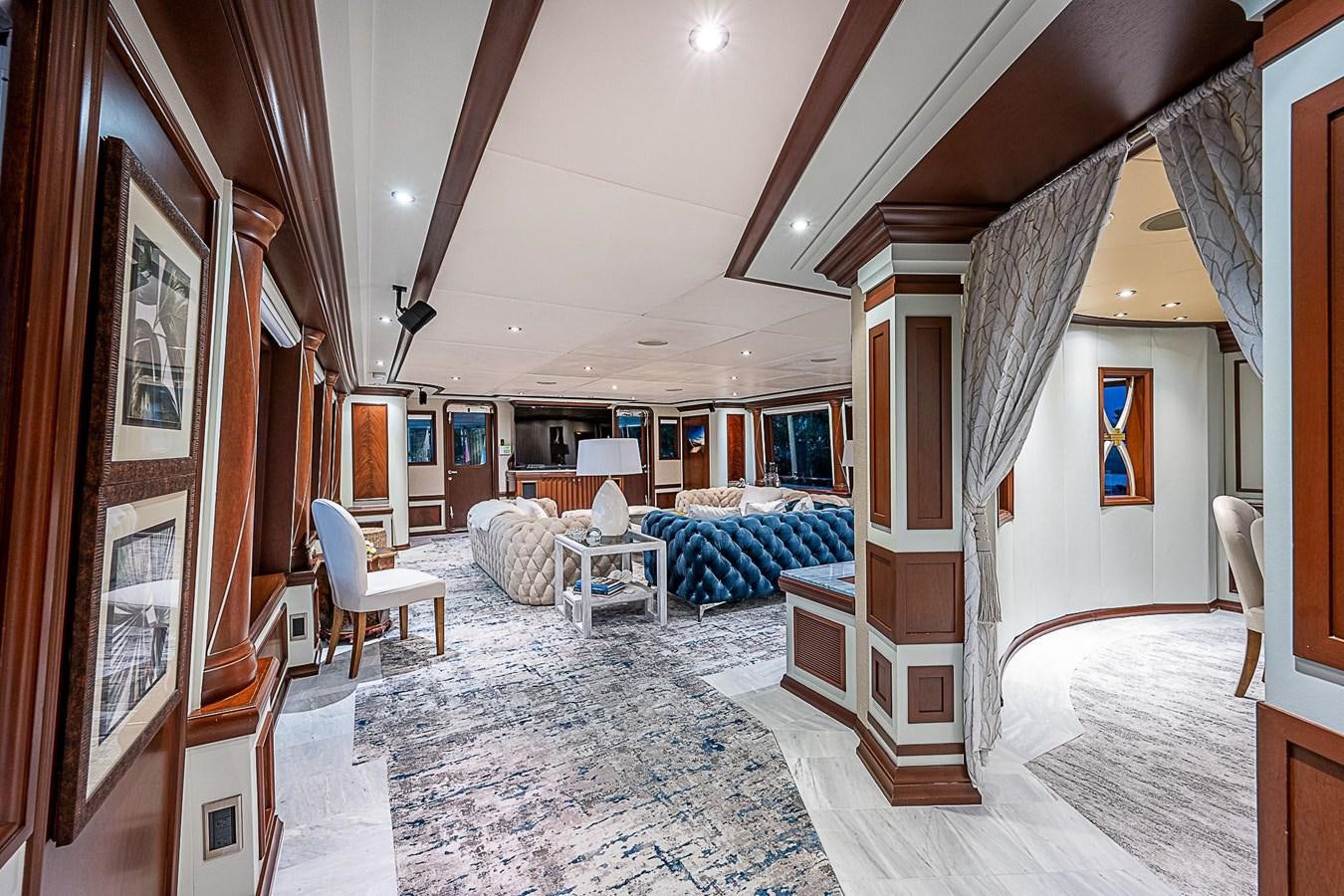 a living room with a large mirror aboard LAGNIAPPE Yacht for Sale