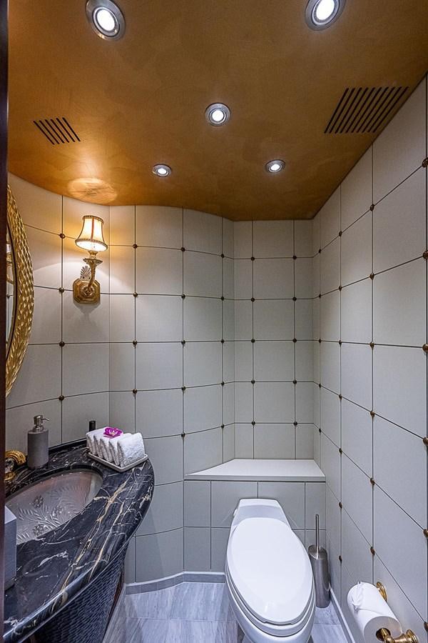 a bathroom with a toilet and sink aboard LAGNIAPPE Yacht for Sale