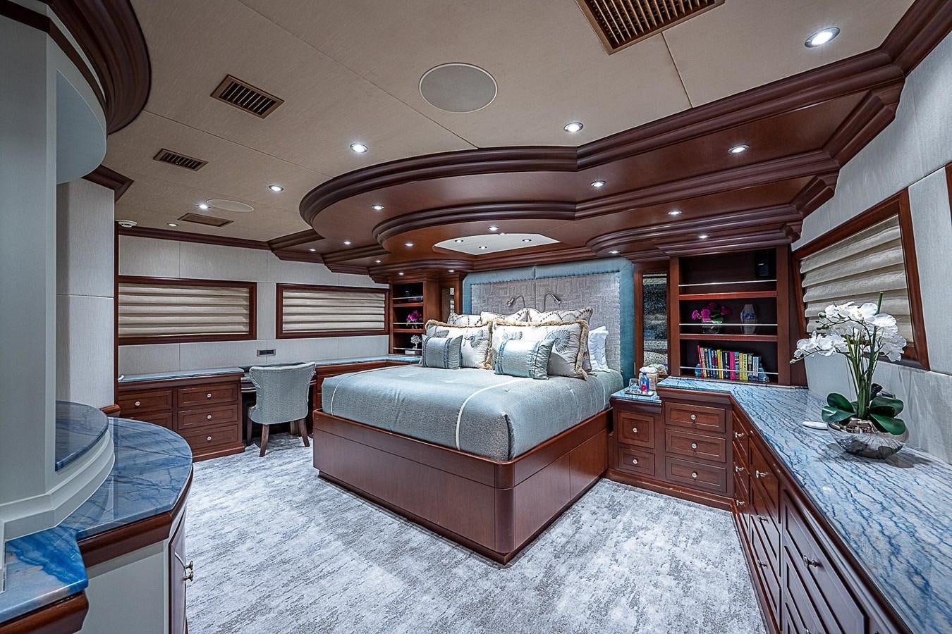 a large living room with a large white couch and a large mirror aboard LAGNIAPPE Yacht for Sale