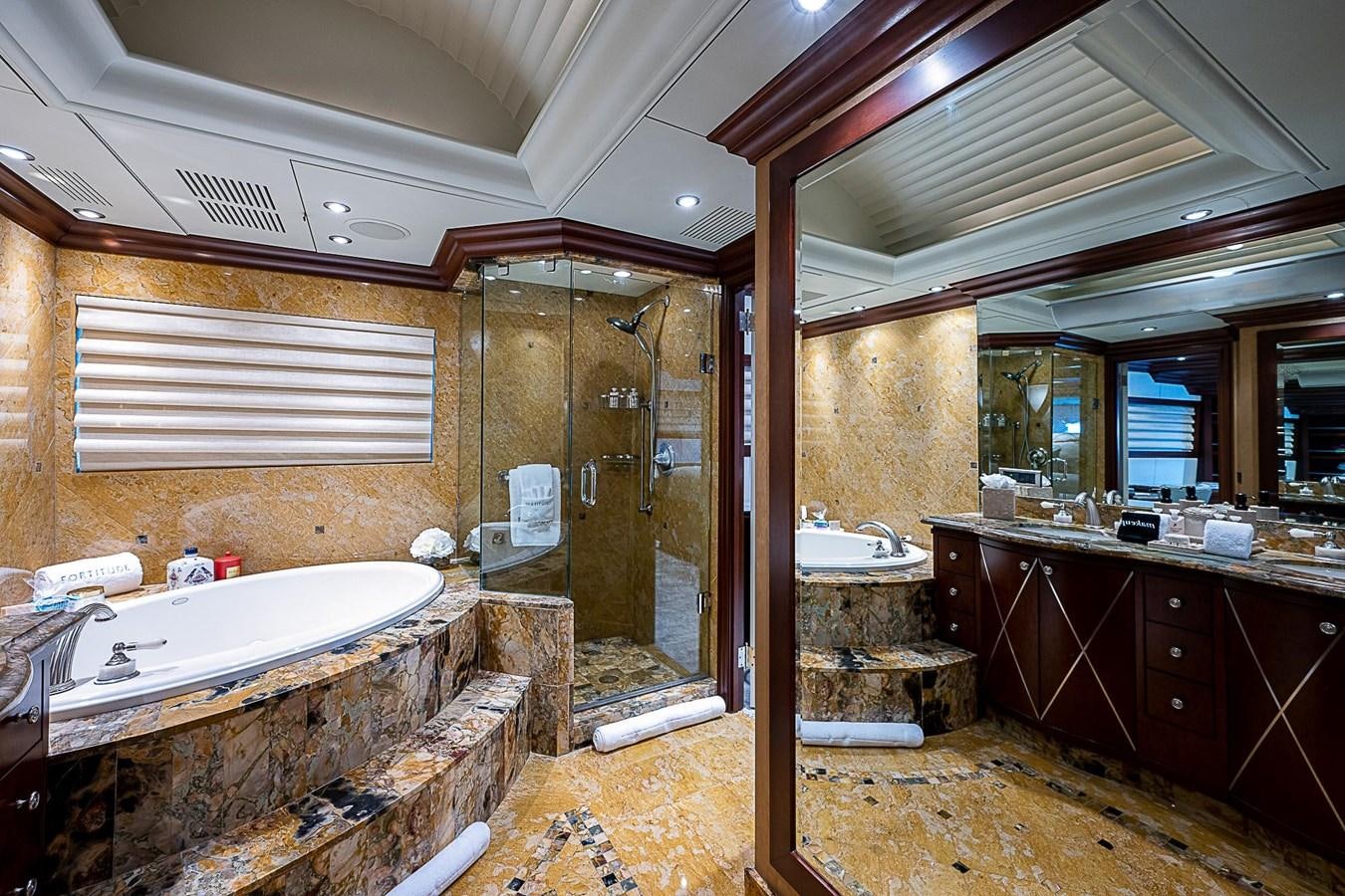 a bathroom with a large tub aboard LAGNIAPPE Yacht for Sale
