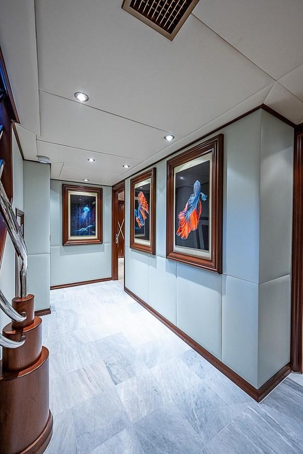 a hallway with art on the wall aboard LAGNIAPPE Yacht for Sale