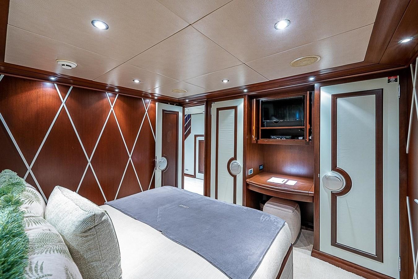 a bedroom with a bed and a television aboard LAGNIAPPE Yacht for Sale