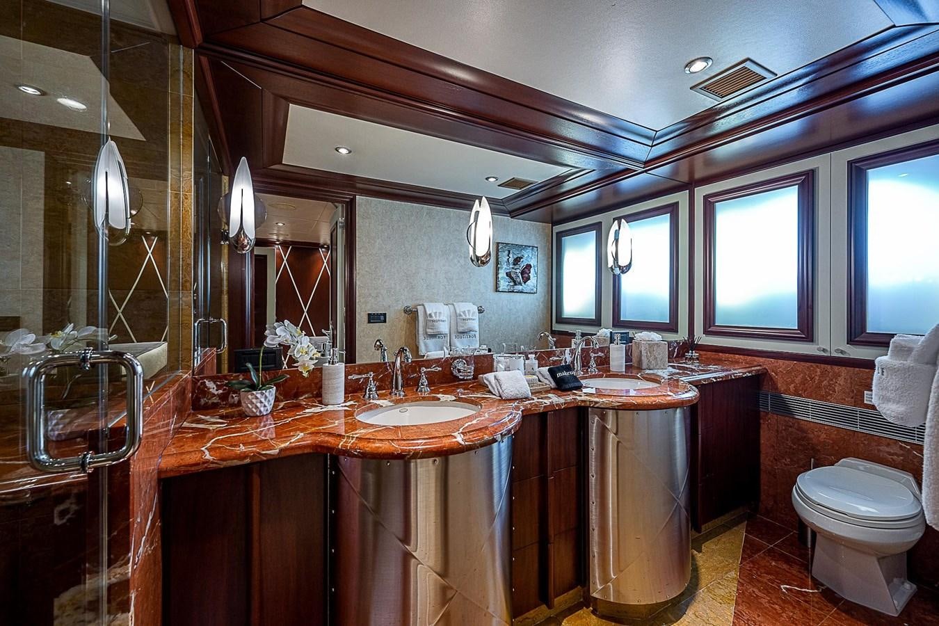 a bathroom with a sink toilet and a mirror aboard LAGNIAPPE Yacht for Sale